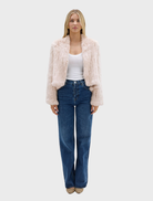 Elegant stone fur jacket by Emma, displayed to showcase its plush texture and contemporary fashion appeal.