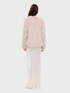 Emma Jacket, stone color, made of up-cycled rabbit fur, showcases an open front and a trendy short-to-long silhouette.