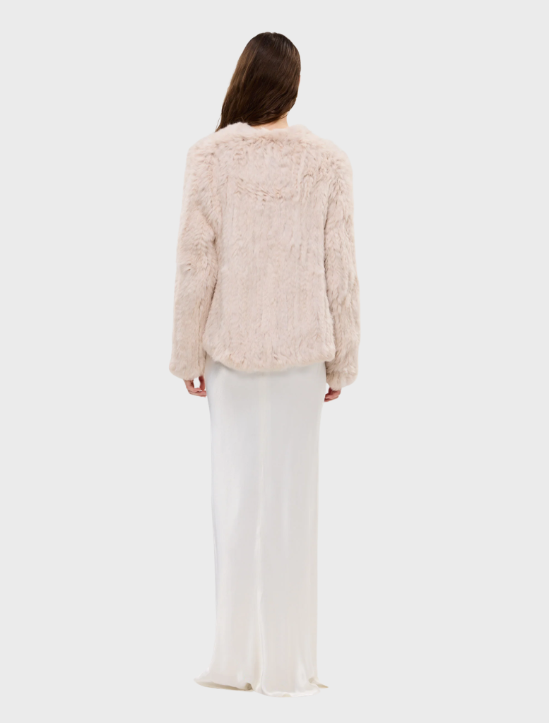 Emma Jacket, stone color, made of up-cycled rabbit fur, showcases an open front and a trendy short-to-long silhouette.