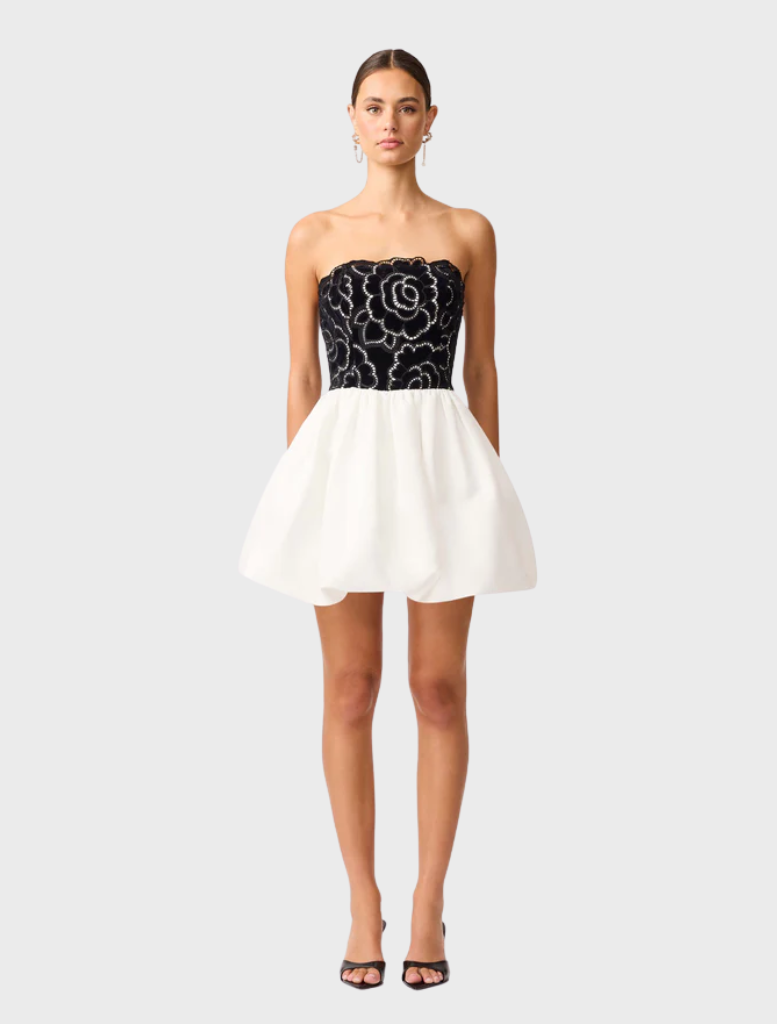 Black and white strapless mini dress with a fitted silhouette, showcasing a stylish and modern design.