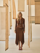 Mid-weight espresso skirt featuring a handkerchief hem and a removable belt with natural gemstones for a stylish touch.