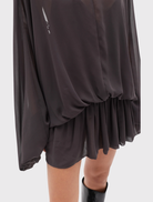 Truffle Evariel Mini Dress includes a boat neckline, sheer upper, voluminous sleeves, gathered waist, and a softly flared mini skirt.