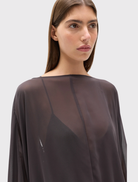 Evariel Mini Dress, Truffle color, features a boat neckline, sheer fabric, voluminous sleeves, and a low open back with criss-cross straps.
