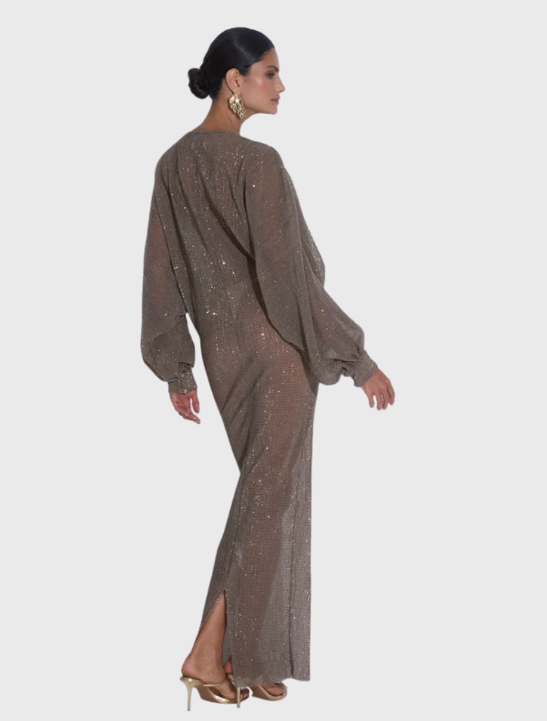 Experimental gown featuring a deep plunging neckline, long sleeves, and a floor-length silhouette in luminous sequin fabric.