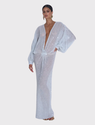 Floor-length Experimental Gown in sparkle, featuring a plunging neckline and voluminous long sleeves for modern elegance.