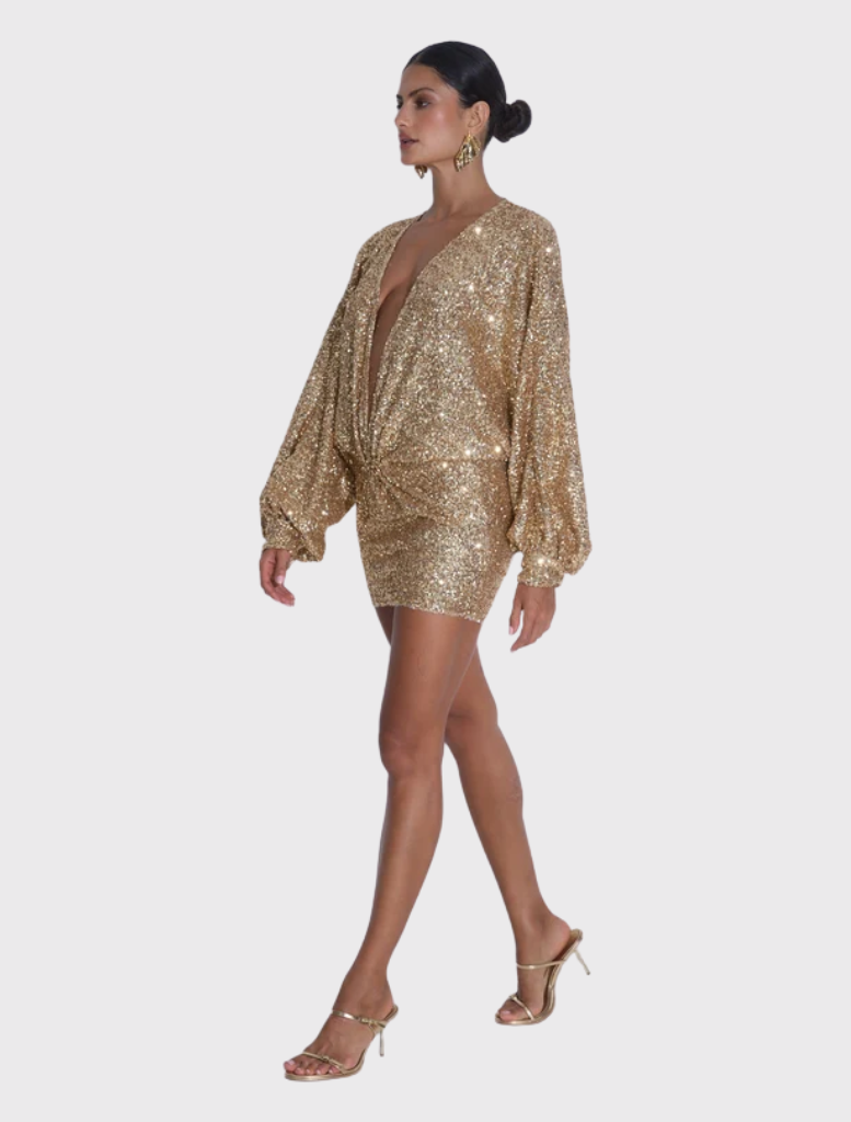 Mini dress in gold sequins, showcasing a deep neckline, voluminous sleeves, and a relaxed silhouette with an open hem.