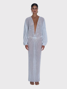Sparkle gown with a plunging neckline and relaxed long sleeves, showcasing a fluid silhouette and luxurious texture.
