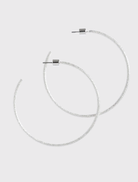Silver Extra Her Hoops by Emma Pills feature a hammered finish and stud back closure, designed for sensitive ears.
