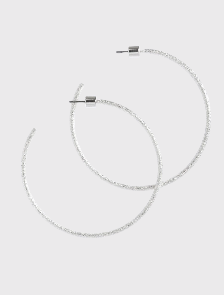 Silver Extra Her Hoops by Emma Pills feature a hammered finish and stud back closure, designed for sensitive ears.
