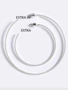 Emma Pills' silver Extra Her Hoops showcase a hammered design, stud closure, and are suitable for sensitive ears.