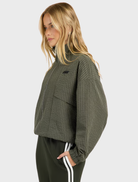 Relaxed-fit olive check jacket with a funnel neck, two-way zip closure, and angled pockets for modern layering.