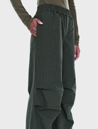 Relaxed olive check pull-on pant featuring a soft polyester blend, wide-leg design, and adjustable drawcord for comfort.