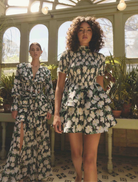 Short sleeve mini dress adorned with a vibrant floral pattern, perfect for casual outings or summer events.

