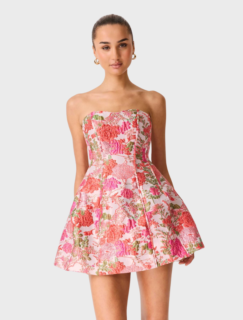 Stylish pink floral mini dress without straps, designed for a trendy summer appearance with a flared skirt.