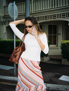 Elegant blush stripe midi skirt with a frill hem, ideal for adding a feminine touch to any outfit.