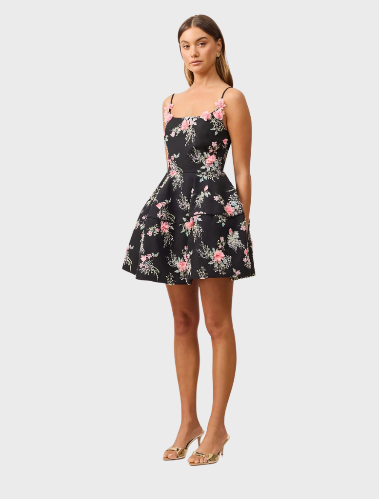 Black floral mini dress by Gaia, showcasing a chic pattern and a feminine fit for versatile styling.