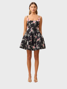 Black Gaia Floral Mini Dress featuring a vibrant floral pattern and a flattering silhouette for a stylish look.