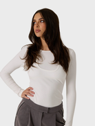 Chic white double layer top, offering a modern silhouette and ideal for layering with other clothing items.