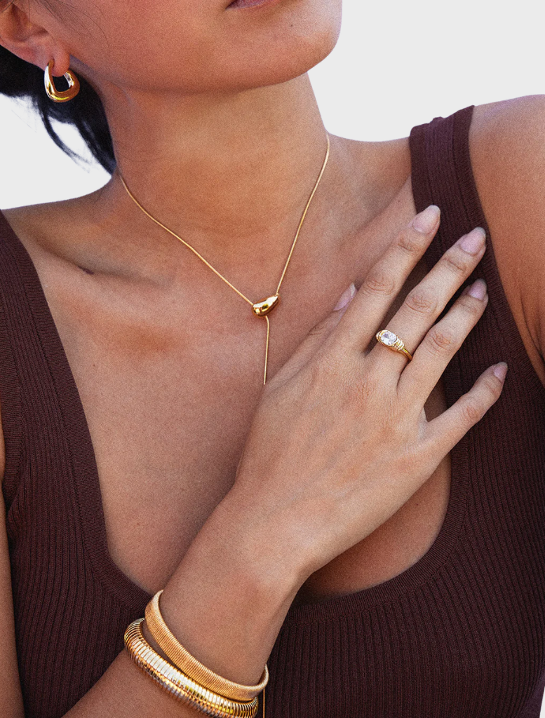 Gold cuff bracelet by Sabrina, combining simplicity and elegance in its design.