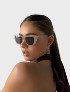 Hailey II sunglasses with a nude color frame and grey lenses, offering a chic and contemporary look.