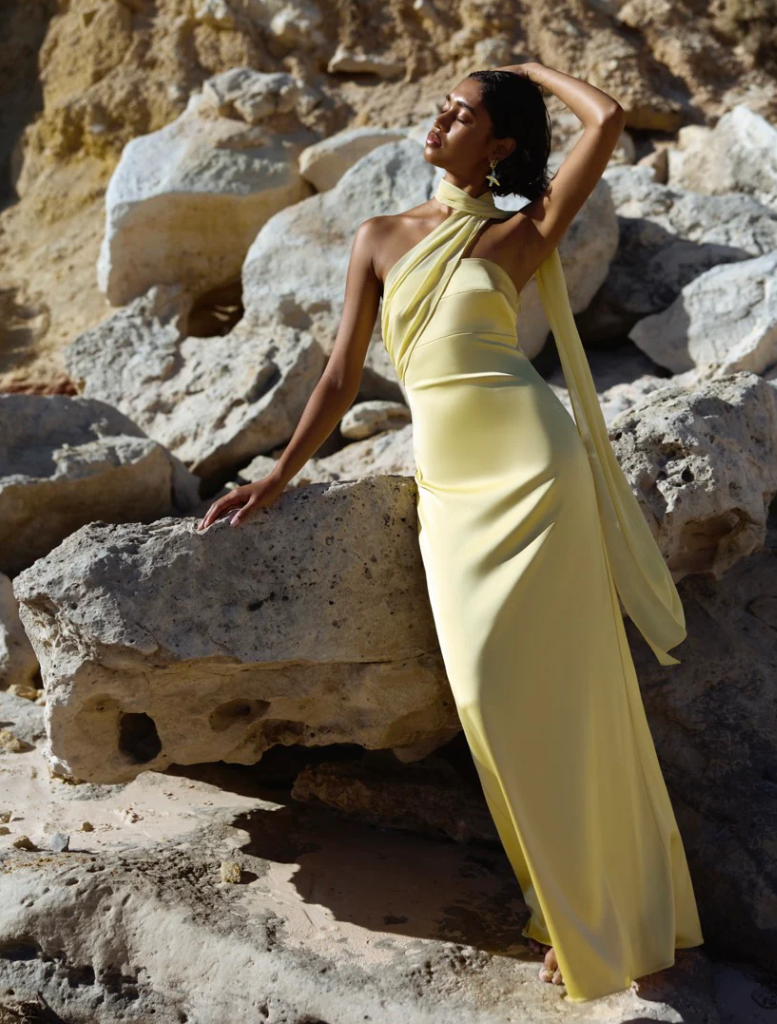 Sunflower Hali Dress, showcasing a vibrant yellow color and elegant silhouette, ideal for warm-weather events.