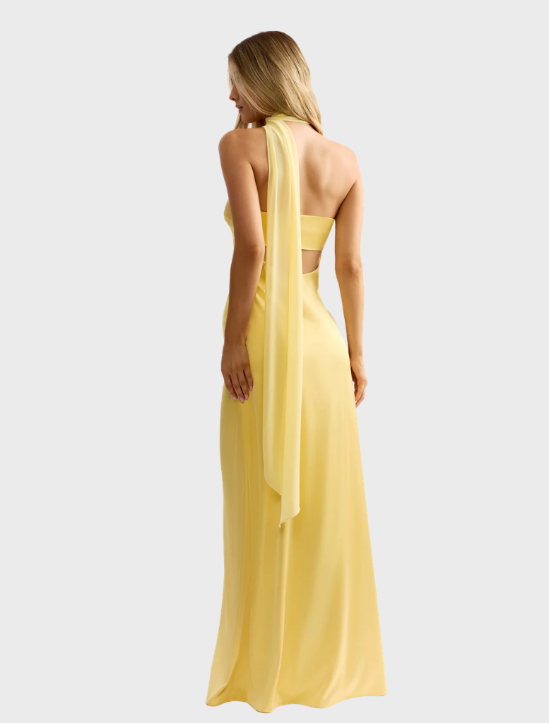 Hali Dress in a sunny yellow shade, featuring a graceful design and floral details, perfect for summer gatherings.