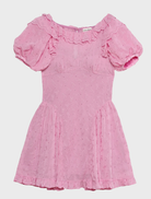 Feminine pink mini dress with eyelet detailing, offering a light and airy style ideal for warm weather occasions.