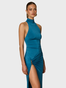 Helena Gown in Ocean, characterized by its beautiful drape and vibrant color, offering a timeless and elegant style.