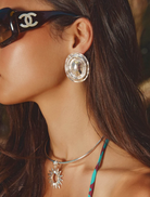 Elegant silver earrings featuring a radiant hand-hammered finish, 4.5cm drop, and omega backing for pierced ears.

