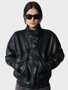 Black Inez Jacket displayed on a hanger, featuring a sleek design and modern silhouette suitable for various occasions.
