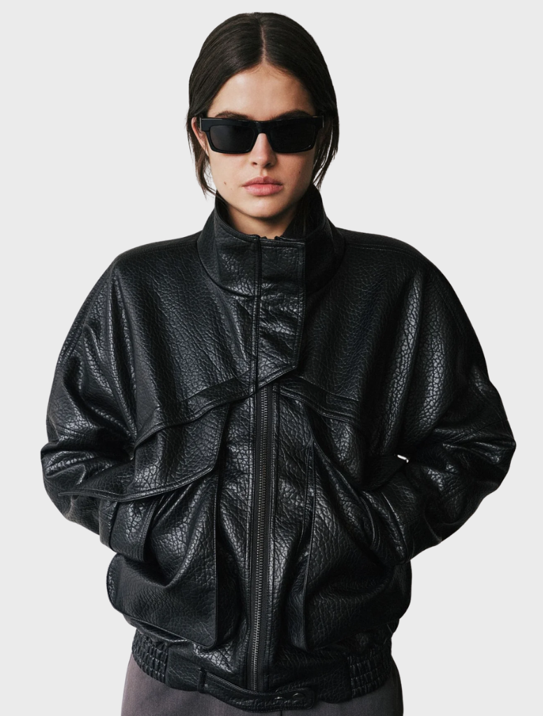 Black Inez Jacket displayed on a hanger, featuring a sleek design and modern silhouette suitable for various occasions.