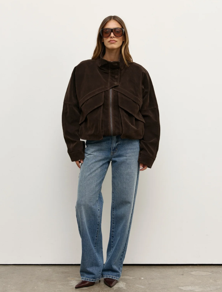 Deep brown Inez jacket displayed on a hanger, featuring a sleek design and modern silhouette suitable for various occasions.