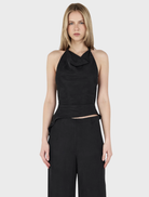 Black leather cropped Iris Halter Top, showcasing a sleek and stylish design.