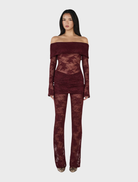 Elegant burgundy lace jumpsuit made from delicate lace, perfect for formal occasions.