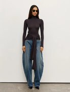 Charcoal Isley Top displayed on a hanger, showcasing its sleek design and fabric texture.