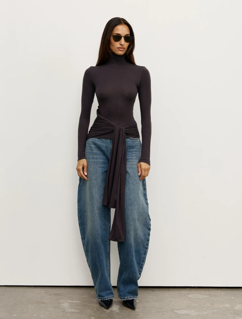Charcoal Isley Top displayed on a hanger, showcasing its sleek design and fabric texture.