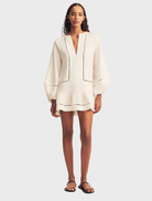 Ivory mini dress with balloon sleeves, featuring a fitted bodice and flared skirt, ideal for casual or semi-formal occasions.