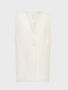 Ivory sleeveless blazer by Otis, featuring a tailored design suitable for formal or casual occasions.