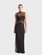 Black high neck maxi dress featuring intricate lace detailing, elegant silhouette, and flowing skirt for a sophisticated look.