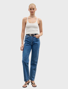  White Jayla tank top displayed on a hanger, featuring a simple design and lightweight fabric suitable for warm weather.
