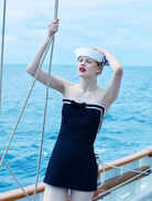 Stylish black strapless mini dress designed for a flattering fit, ideal for parties or formal gatherings.