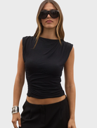 Juniper top in shadow, showcasing a sleek design with a dark color palette and elegant silhouette.