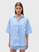 Relaxed-fit Kanzo Shirt in blue stripes, showcasing a white collar, button closure, and short wide sleeves for comfort.
