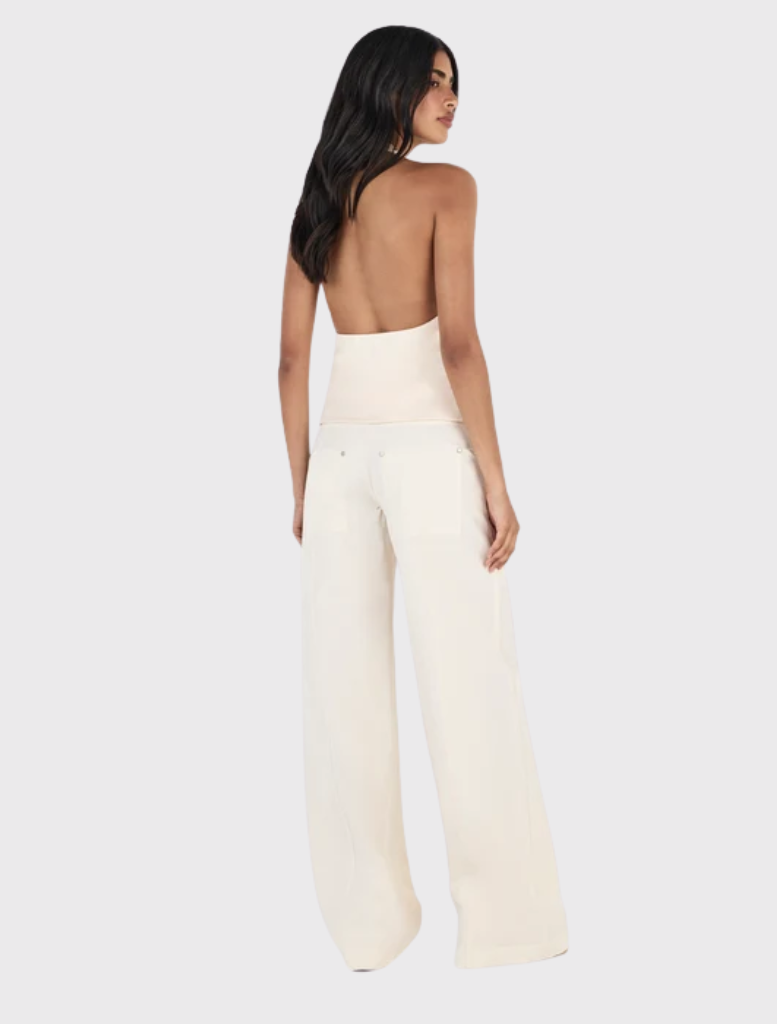 The Kehlani Pant in Cream offers a relaxed straight leg, low-rise style, zip fly, belt loops, and multiple pockets for utility.