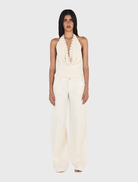 Cream Kehlani Pant features a relaxed straight leg, low-rise fit, zip fly, belt loops, and functional pockets for everyday wear.