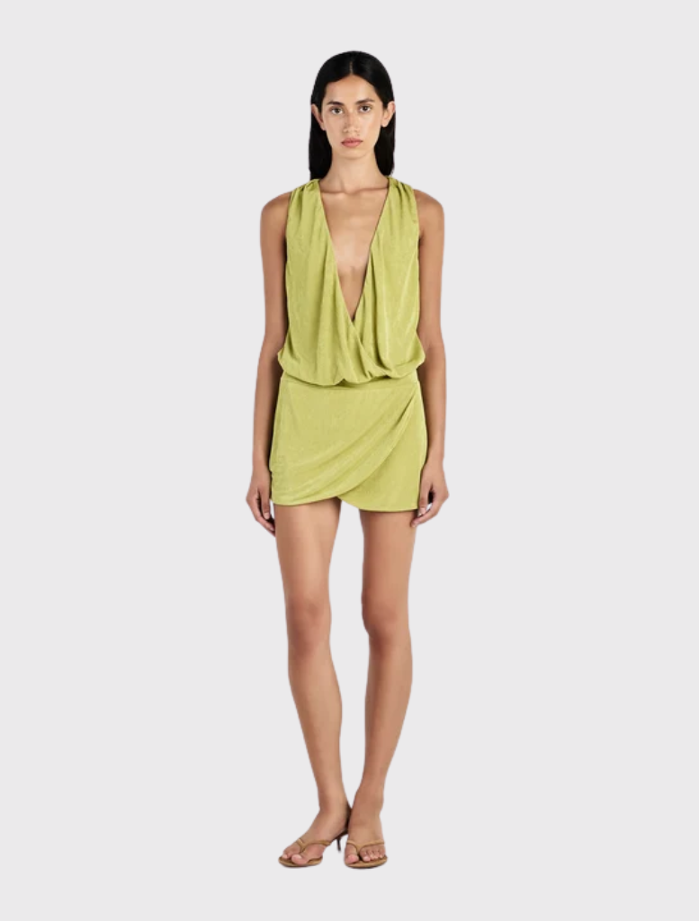 Featuring a relaxed bodice and fitted mini skirt, the Chelley Mini Dress in Kiwi has a deep V neckline and cowl design.