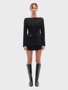 Black Laurent blazer displayed on a hanger, showcasing its tailored design and sleek silhouette.