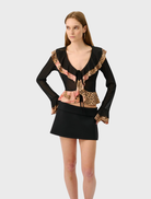 Stylish frill cardigan in a mesh fabric adorned with a bold leopard print, perfect for adding flair to any outfit.