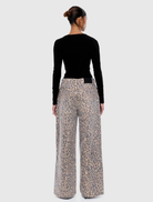 Leopard-patterned Wynn Animal Jean laid flat, emphasizing its trendy design and vibrant colors.