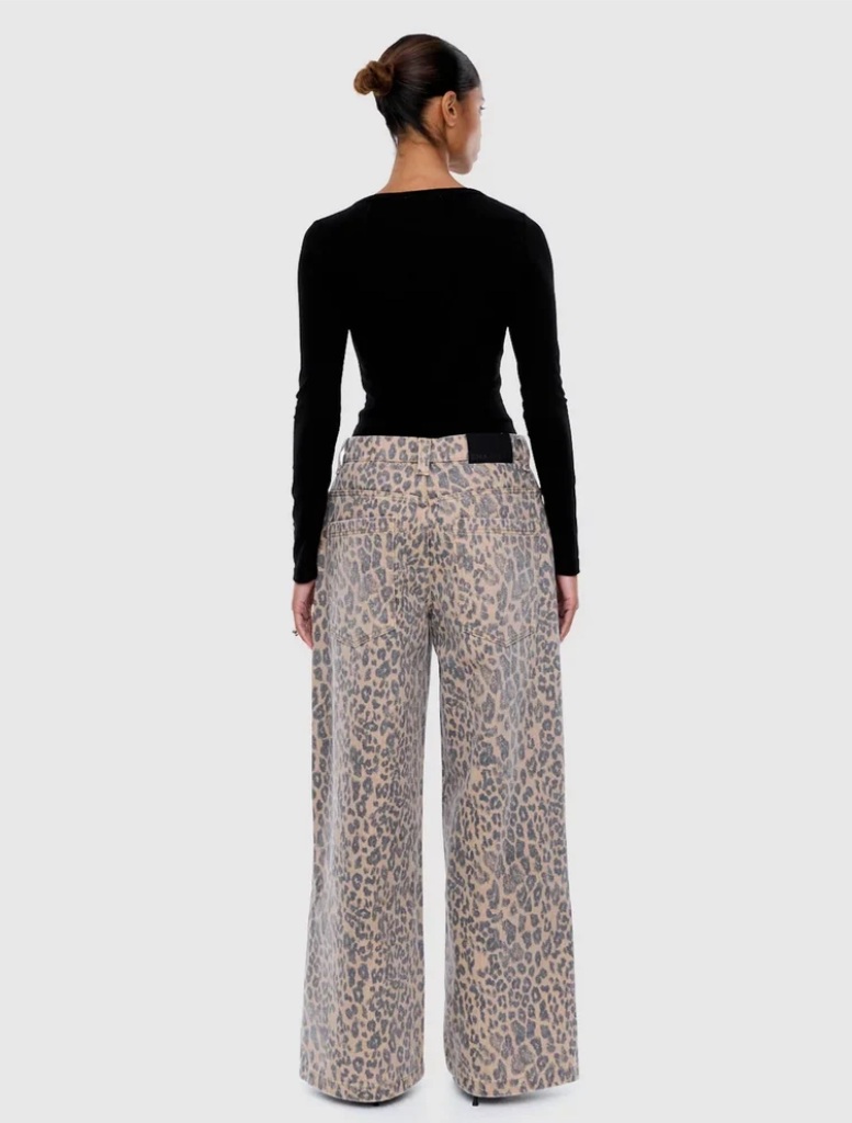Leopard-patterned Wynn Animal Jean laid flat, emphasizing its trendy design and vibrant colors.